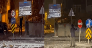 12 yaşındaki Kadir karla kaplanan trafik levhalarını temizledi